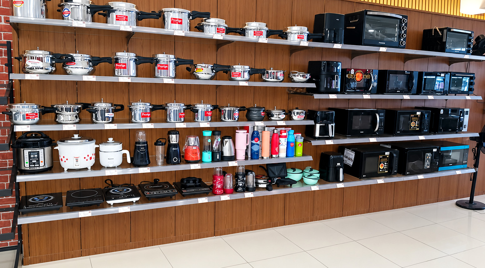 Wood-finish slotted rack wall panelling displaying cookware and small kitchen appliances